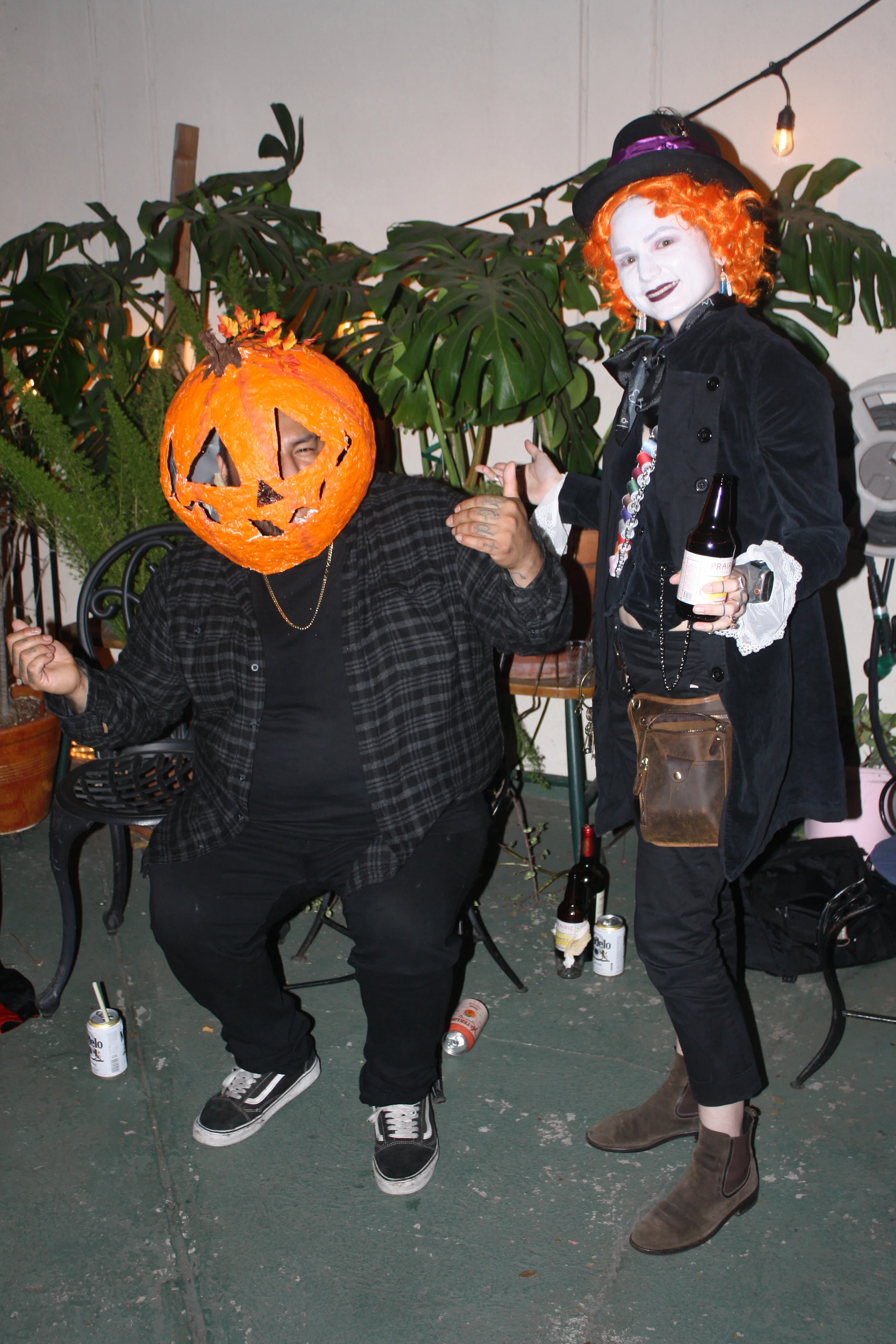 Friends dressed as a pumpkin king and the Mad Hatter